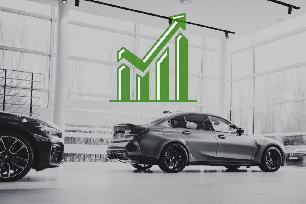 black and white photo - car at a car dealership with a statistic graphic pointing upwards
